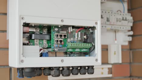 an electrician installing an inverter in a home. the image shows technical skill, modern tools, and attention to safety in electrical work