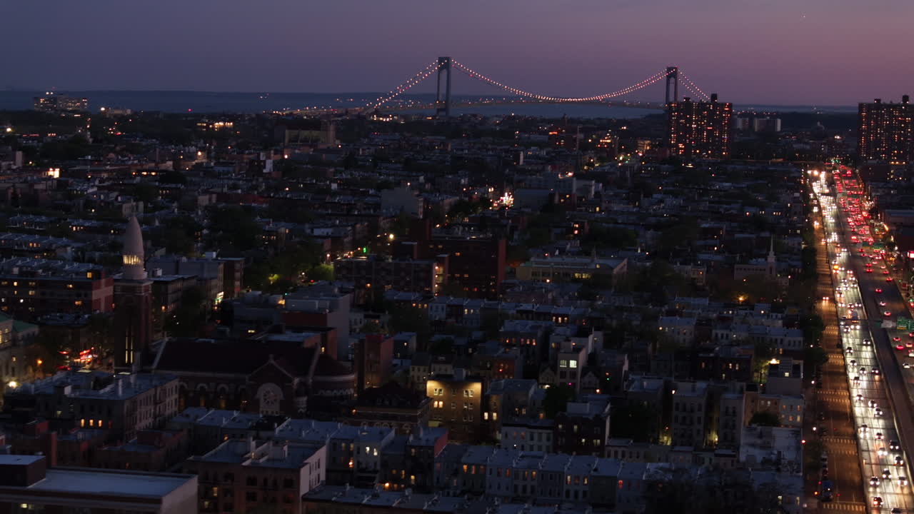 Aerial view of rush hour traffic on Brooklyn's Belt Parkway. Shot at night in Bay Ridge with the Verrazzano Bridge in the background.