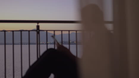 Young-woman-on-a-balcony-near-the-sea