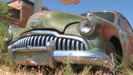 A-tracking-shot-of-an-old-rusting-car