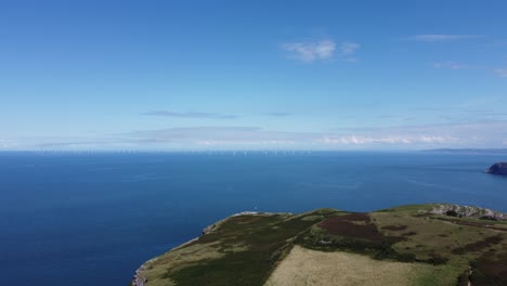 forward moving cinematic 4k drone clip of the gwynt y môr and rhyl flats offshore wind farms from the great orme, wales, uk