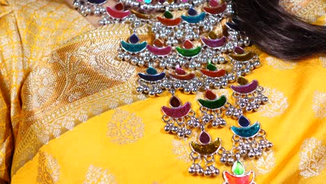 colorful traditional indian necklace on a yellow saree