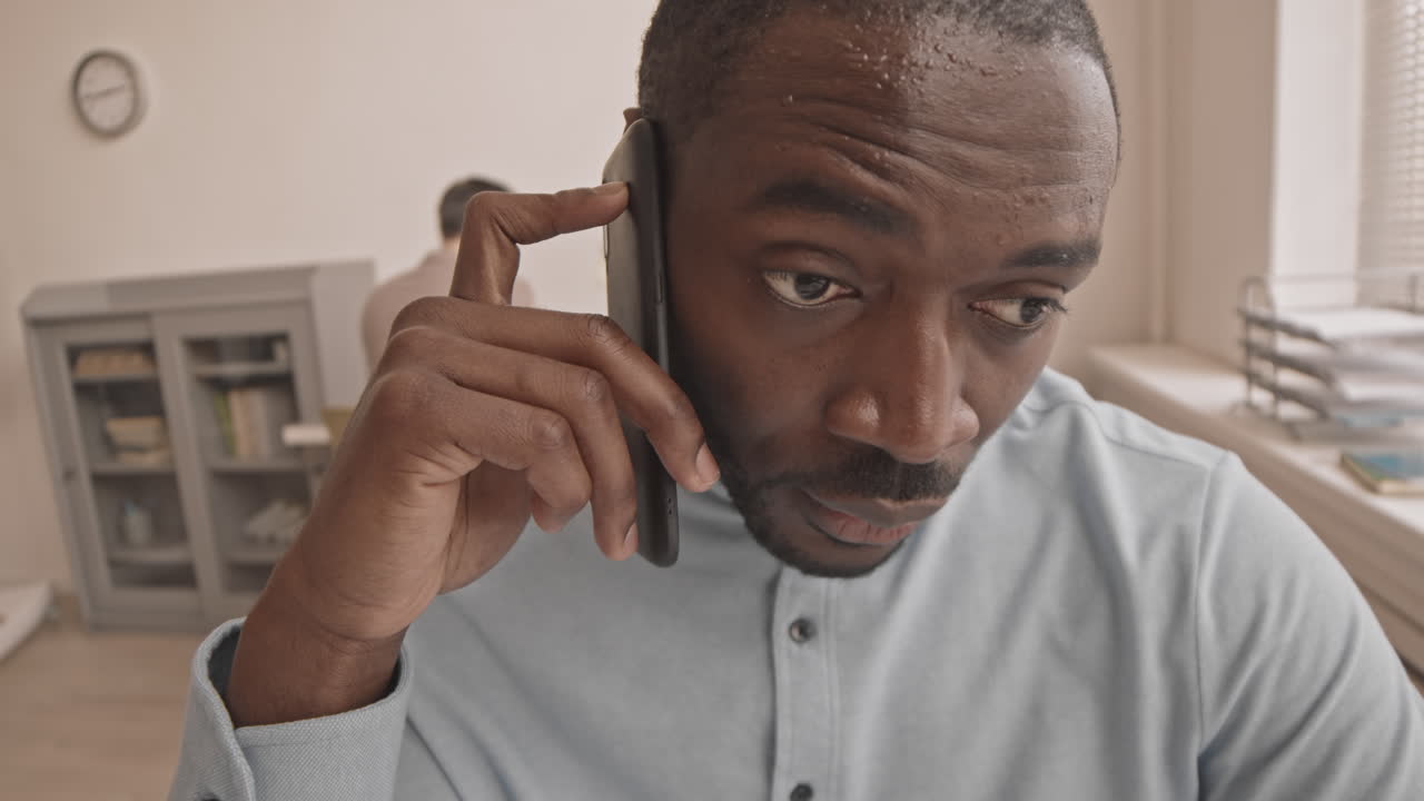 Anxious Employee Talking on Cellphone