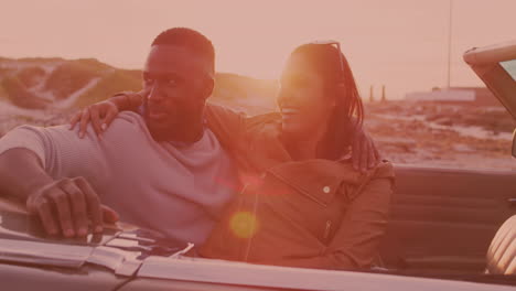 african american couple smiling and enjoying in the car during a roadtrip