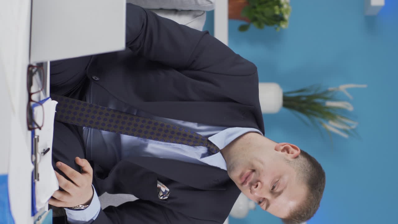 вертикальное видео домашнего офисного работника. мужчина не хочет работать.