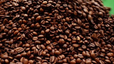 coffee background on green screen.hq coffee transition video. falling coffee concept. top view of freshly roasted coffee beans