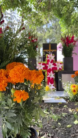 day of the dead gravesite with marigolds and cross