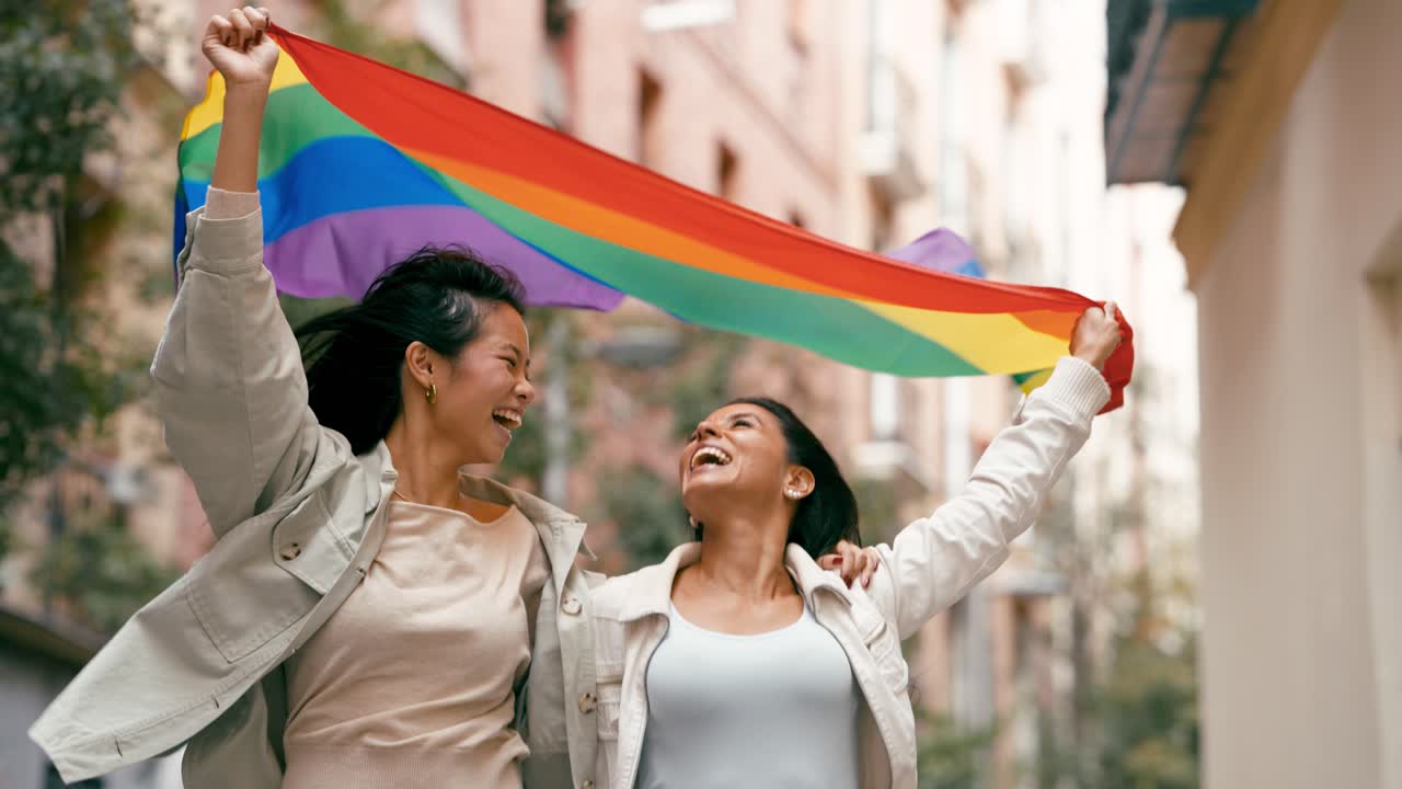 Two Women Celebrate LGBTQ Pride with Rainbow Flag