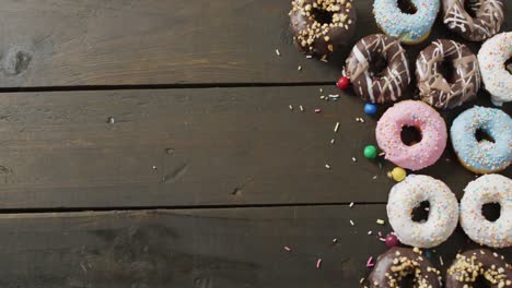 video of donuts with icing on wooden background