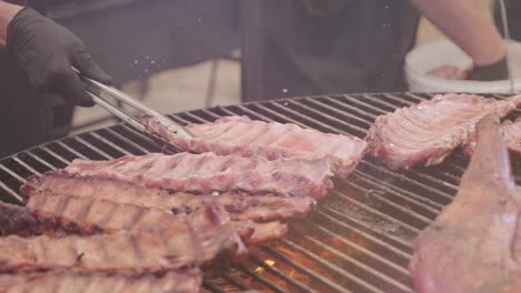 chef hand straightens grilled meat