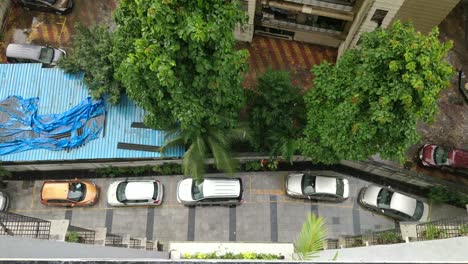 Rain-water-droplets-falling-from-building-ceiling-on-the-cars-parked-below-the-building