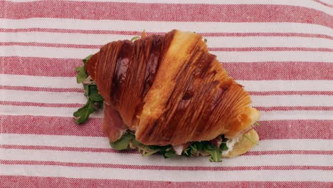 croissant with jamon ham, salmon, in modern cafe, top view of healthy breakfast in cafe. english breakfast: fried egg, bacon toast on sandwich.