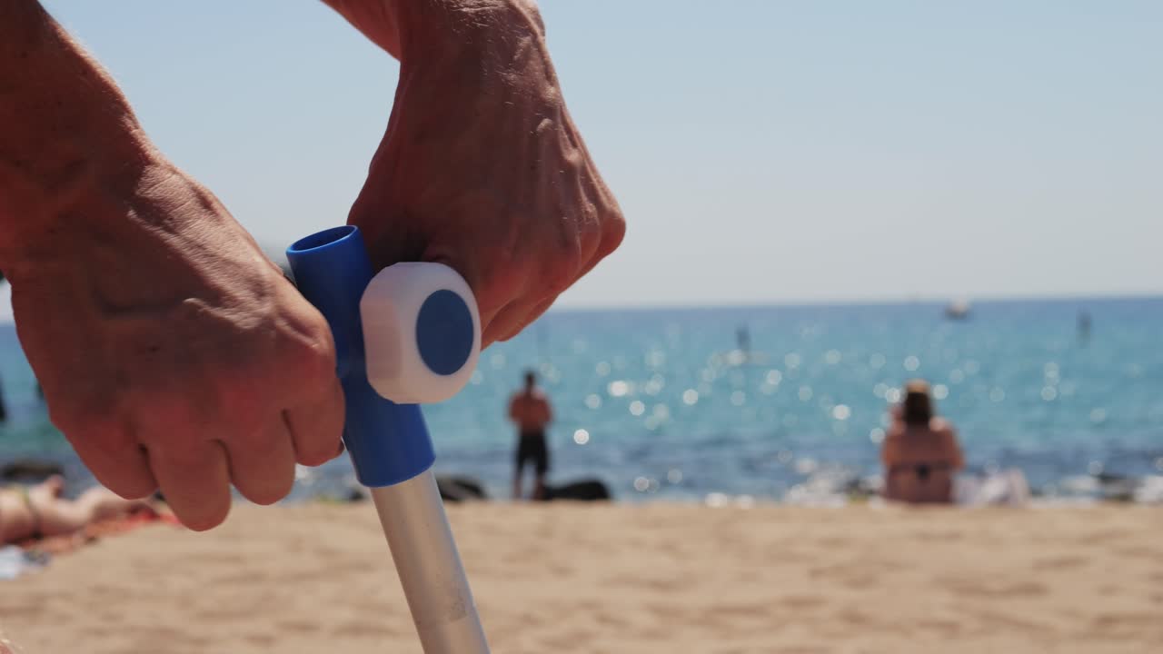 Setting up beach umbrella on the beach