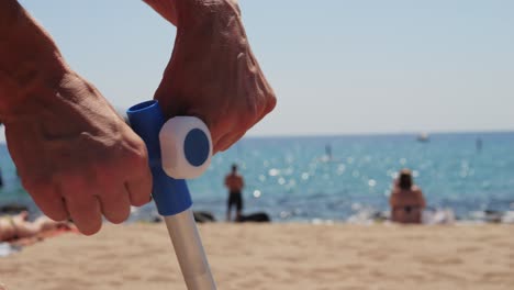 setting up beach umbrella on the beach