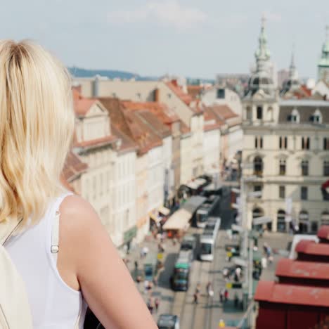 A-Young-Woman-Tourist-Is-Admiring-The-Old-European-City-From-A-Height-1