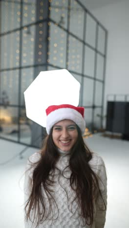 woman wearing santa hat in studio