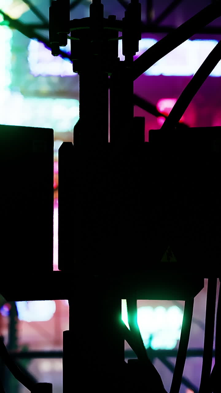 Neon lights illuminate urban street surrounded by wires and shadows at night