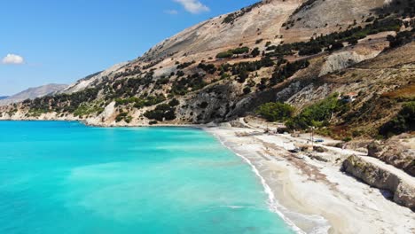 white sandy beach of agia kyriaki at the bottom of the hill - aerial shot