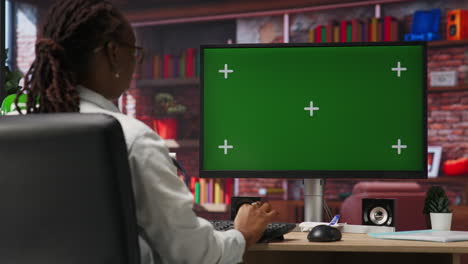 student at home browsing internet on green screen computer