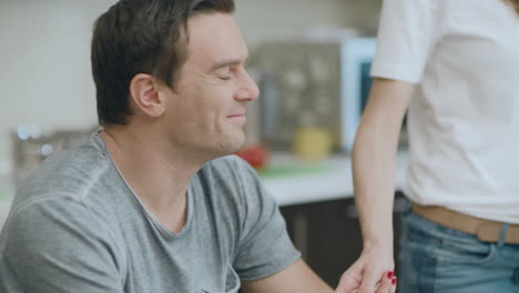 Closeup-happy-couple-talking-during-healthy-breakfast-in-living-room.