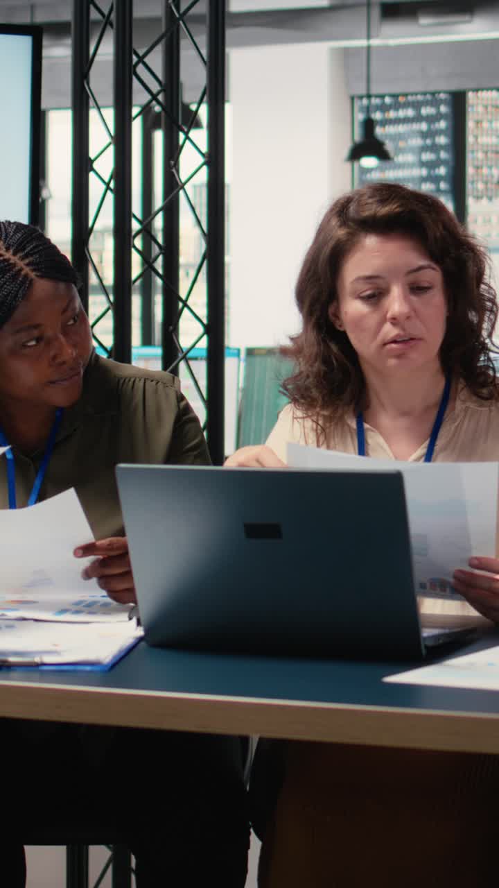 Vertical Video Group of businesswomen engaging in collaboration during briefing session