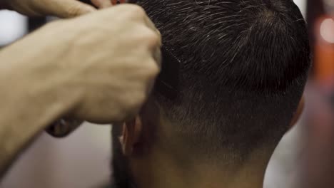 Close-up-Of-Barber-Using-Trimmer-On-Hair-Of-Customer