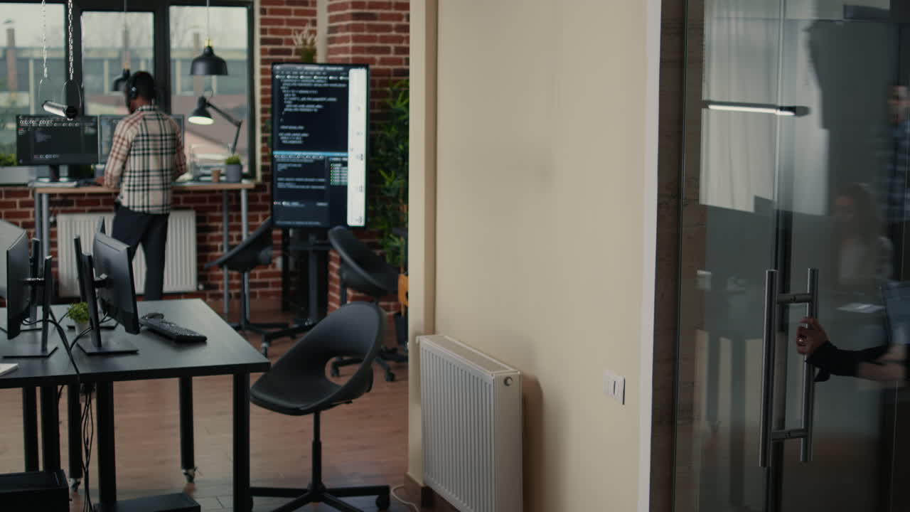 Software developer holding laptop with source code algorithm entering programmers agency office