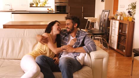 couple relaxing on sofa in the living room