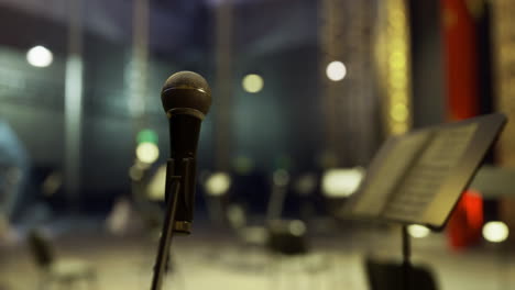 microphone ready for performance in an empty concert hall at night