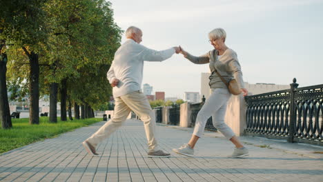 happy older couple dancing outdoors
