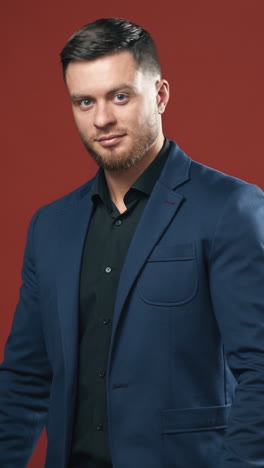 young handsome businessman. portrait of businessman standing on studio background. vertical video