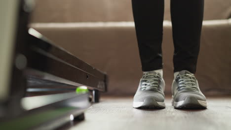 woman in athletic wear standing on a treadmill