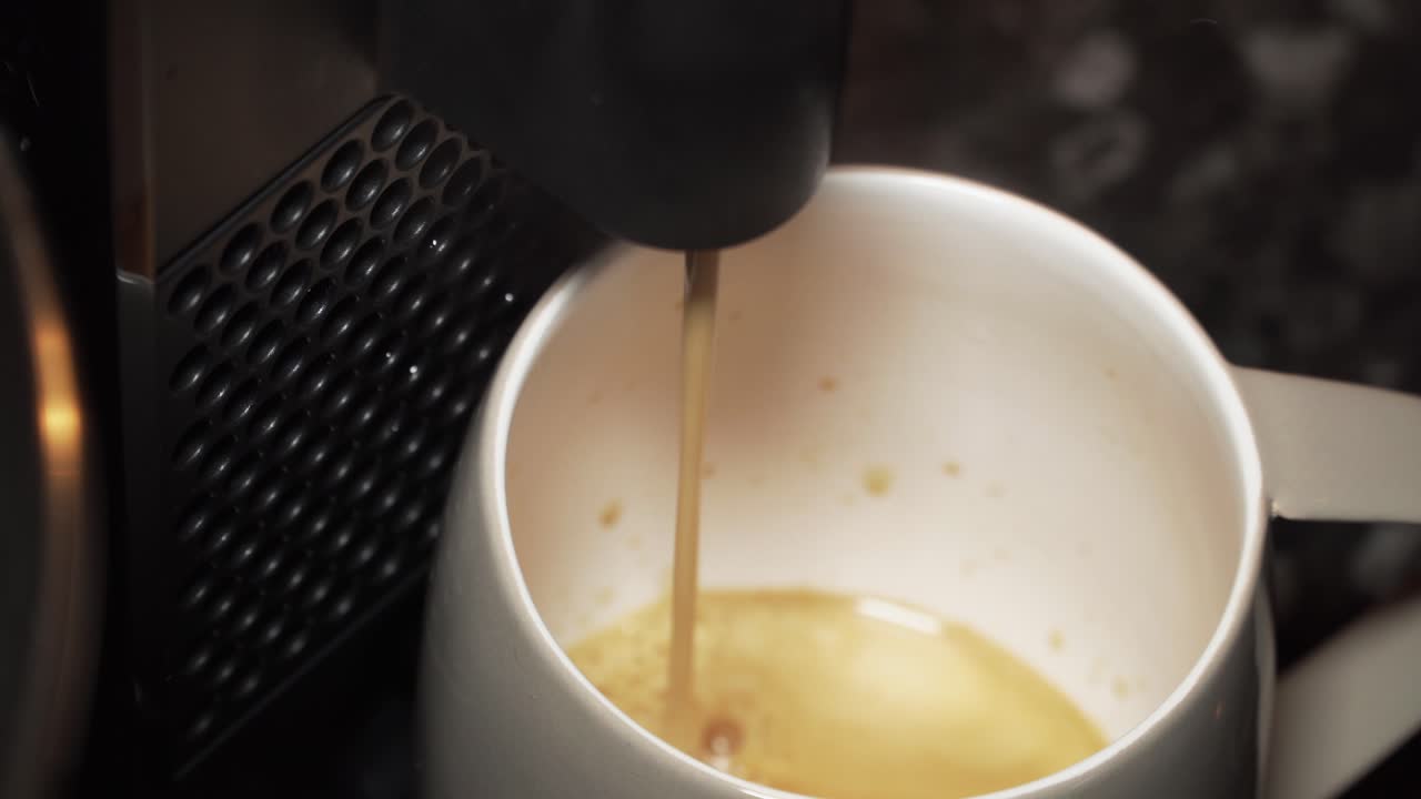 Close up shot of coffee machine making coffee into a grey cup