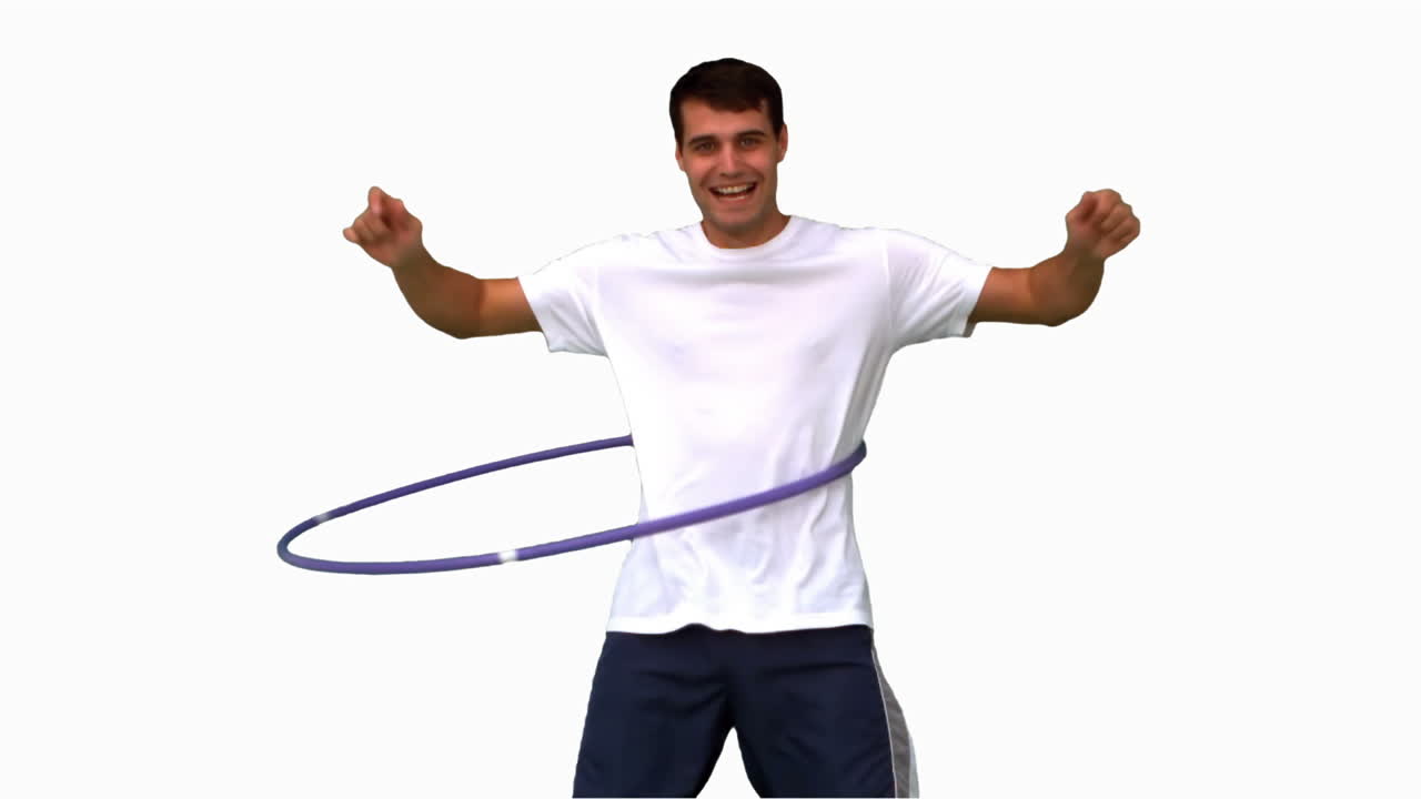 Man playing with a hula hoop on white screen