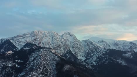 panorama of snowy tatra mountain range with forest during winter in europe