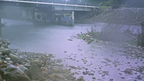 time lapse of a bridge flooding as a winter storm dumps rain into a river