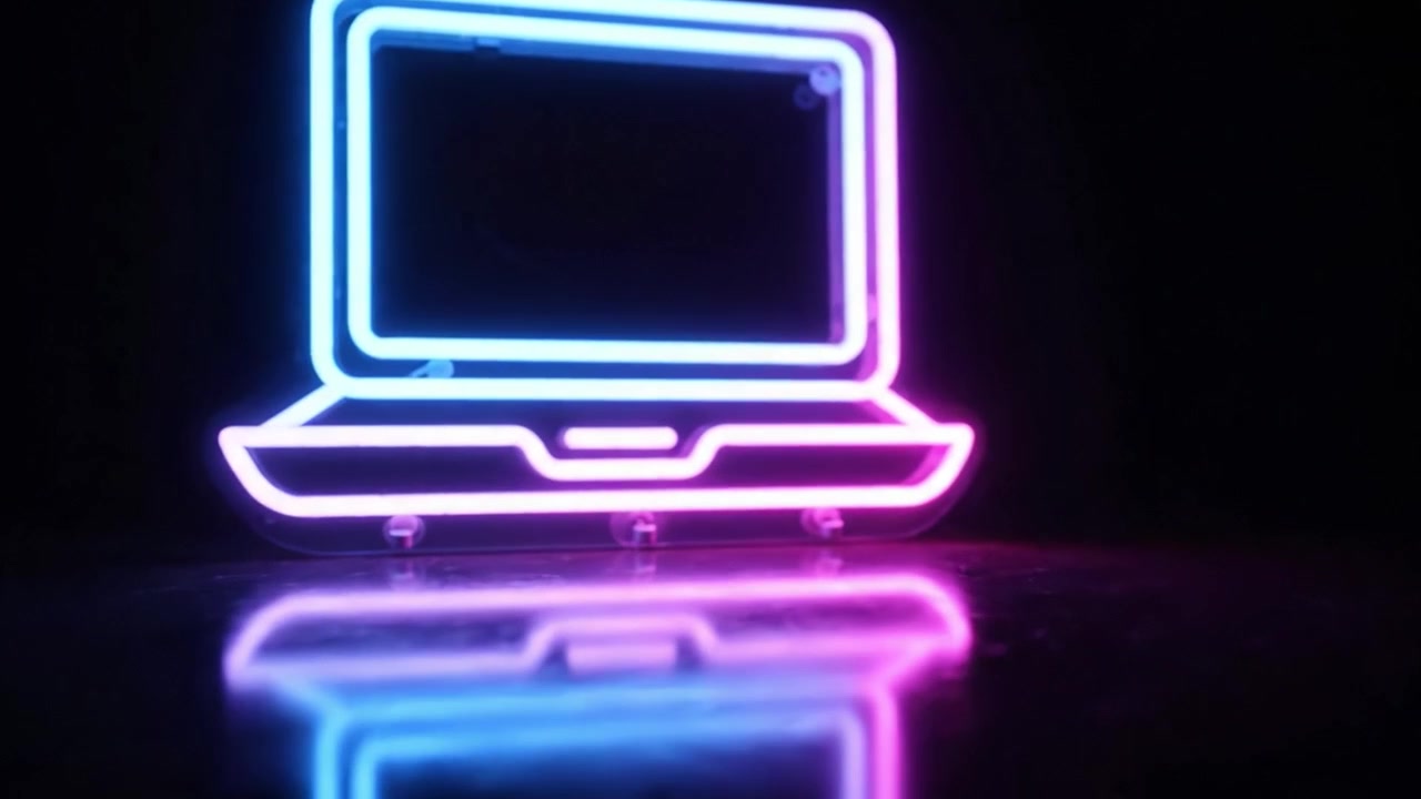 Mesmerizing Neon Laptop Animation with Vibrant Colors Reflecting on a Dark Surface, Showcasing Modern Design and Aesthetic Charm