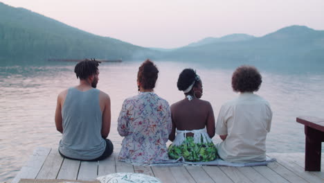 Friends Sitting on Pier and Talking about Scenic Lake View
