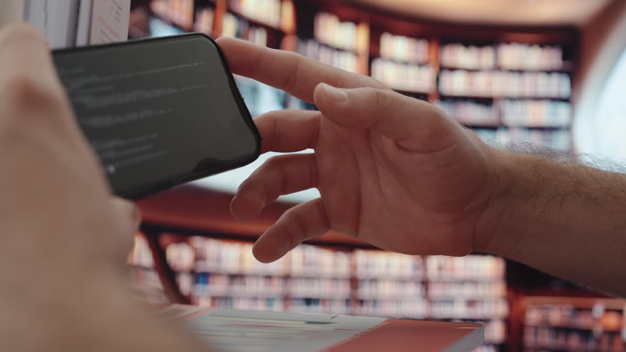 Close-up of a hand using a smartphone with AI content on screen, set in a library environment—showing modern digital learning and research