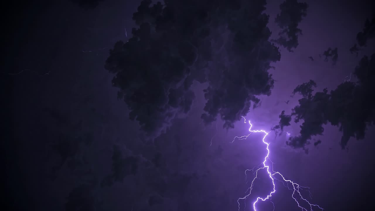 Dramatic video still of a lightning storm, captured from a low angle