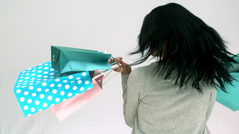 Woman-spinning-around-with-shopping-bags