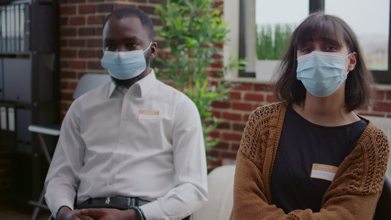 Woman having discussion with people about addiction at aa group meeting therapy