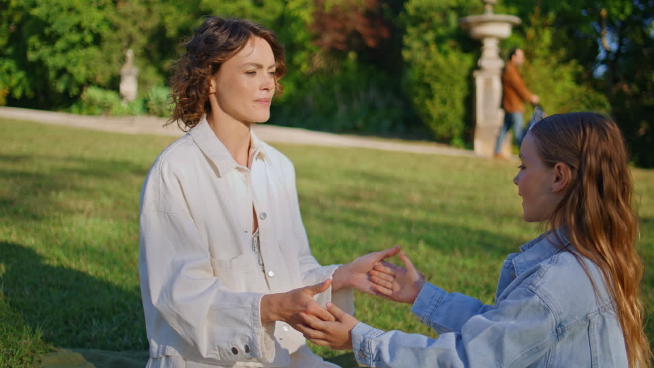 Summer woman girl playing together at lawn zoom on. Mother kid clapping hands