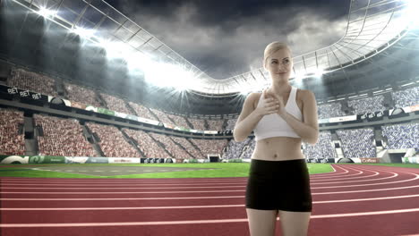 female athlete clapping hands in stadium