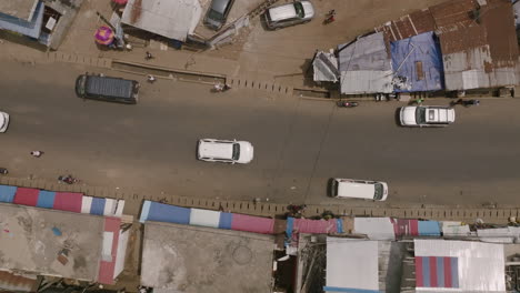 top down aerial footage of cars moving across the road in freetown, sierra leone