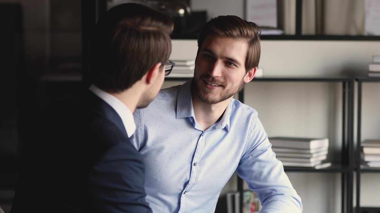 Happy businessmen enjoying interesting conversation, sharing knowledge.