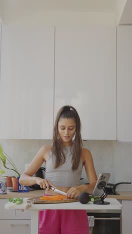 young woman prepares vegetables in a modern kitchen