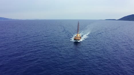 4k drone footage – flying around sailing yacht on the move on aegean sea, datça, turkey