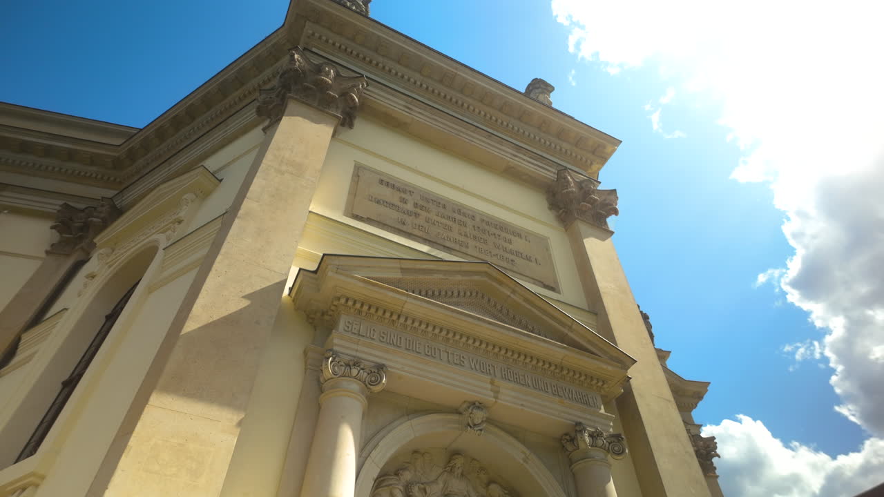 Side view of Berlin’s historic cathedral facade under bright sunlight and clear sky