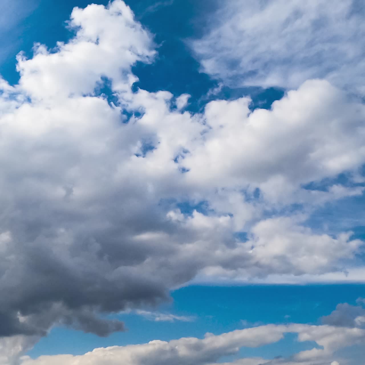 Lovely soft clouds changing shapes quickly in the sky. Diverse types of clouds in atmosphere. Low angle view. Timelapse